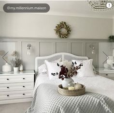 a bedroom with white furniture and decor