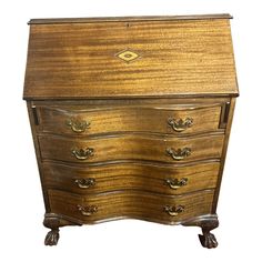 an old wooden desk with drawers on it's sides and gold trimmings