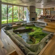 a living room filled with lots of furniture and green moss growing on the floor in front of a fire place