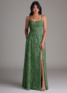 a woman in a long green dress with a slit down the side and one leg