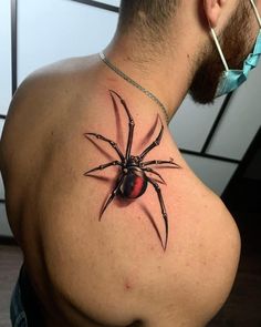 a man with a spider tattoo on his back