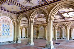 the inside of an old building with many arches and stained glass on the ceiling,