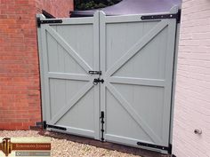 a large gray gate in front of a brick building