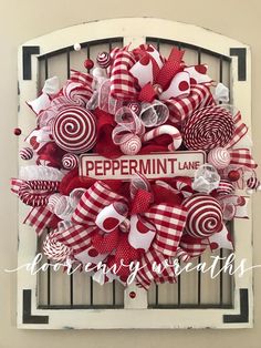 a red and white wreath with peppermin lane sign