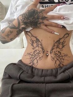 a woman with tattoos on her stomach