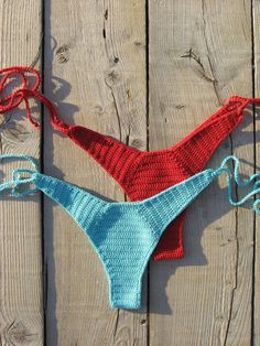 two crocheted bikinisuits on wooden planks