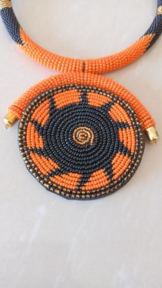 African Necklace, African Jewelry, African Beaded Necklace, Zulu Beaded Necklace, Orange Necklace, Pendant Necklace, Gift For Her This stunning pendant necklace is superbly crafted which makes you stands out in any occasion. Main Color - Orange. Different colors of your choice can be available. Wholesale available at a fair price. For any query please send me a convo or an e-mail. Happy Shopping Traditional Orange Jewelry With Black Beads, Artisan Orange Beaded Necklaces, Artisan Orange Round Beaded Necklaces, Artisan Orange Round Beaded Necklace, Artisan Black Beaded Necklaces For Jewelry Making, Round Black Beaded Necklaces For Jewelry Making, Orange Beaded Necklaces With Spacer Beads As Gift, Orange Spacer Beads For Jewelry Making, Orange Necklace With Black Beads For Gift