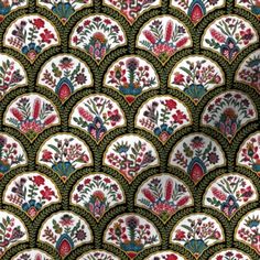 an intricately designed wallpaper with flowers and leaves in green, red, yellow and blue