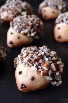 chocolate chip cookies with sprinkles and nuts arranged on a black plate, ready to be eaten