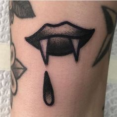 a close up of a person's leg with a tattoo on it and an upside down lip