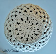 three crocheted white doily sitting on top of each other in the shape of a circle