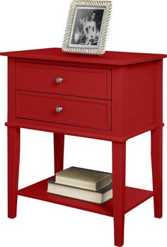 a red nightstand table with two drawers and a photo frame on the top of it