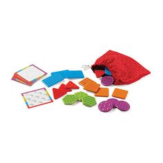 a bag filled with lots of different colored blocks and pieces of paper next to each other