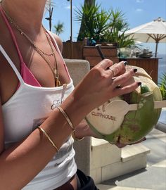 a woman holding a coconut in her hand