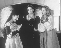 three women dressed in period clothing standing next to each other