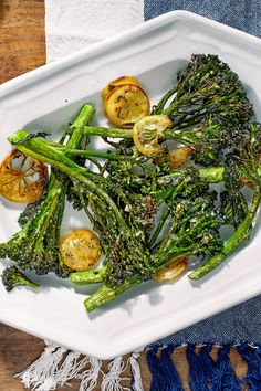 a white plate topped with broccoli and tomatoes