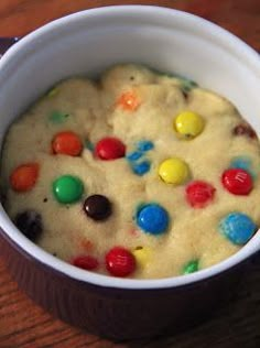 a white bowl filled with cake mix on top of a wooden table