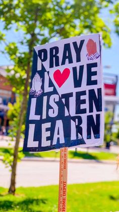 a sign that says pray love listen learn