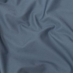 a close up view of a blue fabric textured with polyestere and cotton