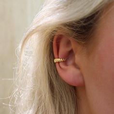 a close up of a person wearing a pair of ear piercings on their ears