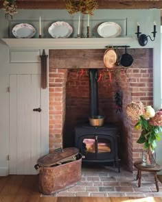 an old fashioned stove in the corner of a room with plates on top of it