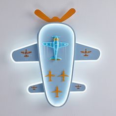 an airplane shaped wall clock with four planes on it's face and one plane hanging from the ceiling