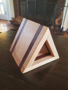 a wooden object sitting on top of a table next to a fireplace in a living room