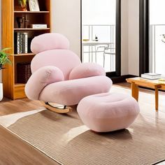 a pink chair and ottoman in a living room