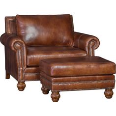 a brown leather chair and foot stool