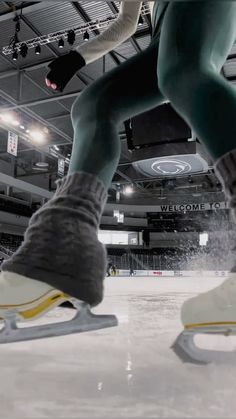 a man riding a skateboard on top of an ice rink