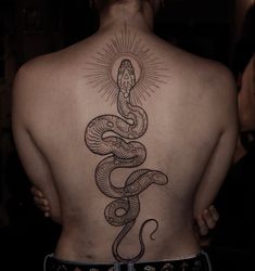 a woman with a snake tattoo on her back