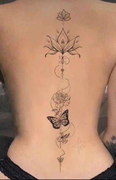 the back of a woman's body with flowers and butterflies on her lower back