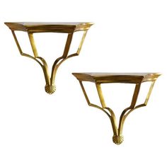 a pair of gold leaf shaped tables on pedestals in the style of art deco