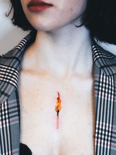 a close up of a person wearing a shirt with a fire on it's chest