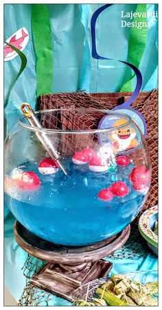 a bowl filled with blue liquid sitting on top of a table