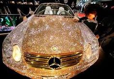 a woman standing next to a car covered in glitter