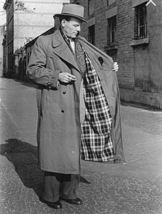 A lined trench coat being modelled in Eastern Germany, 1953. Trench Coat Origin, Trench Coat History, 1920s Trench Coat Men, 1940s Trench Coat Men, Old Trench Coat Men, 1950s Trench Coat Men, 1930s Mens Trench Coat, Trench Coat Ww1, 1960s Trench Coat Men