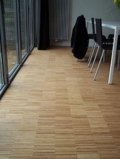 a room with wooden floors and glass doors