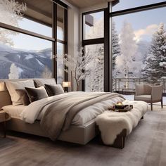 a large bed sitting in a bedroom next to a window filled with snow covered trees