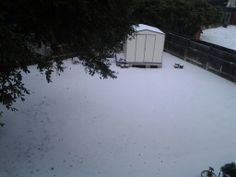 an outhouse in the middle of a snow covered yard