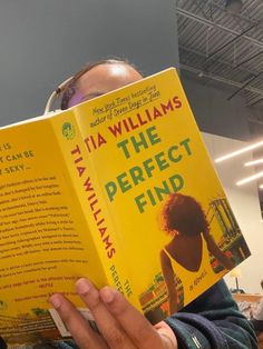 a person holding up a book in front of their face