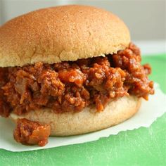 a sloppy joe sandwich sitting on top of a green tray