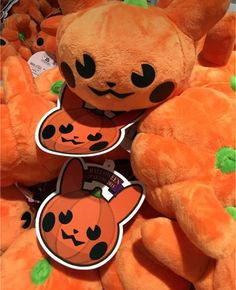 a pile of orange stuffed animals sitting next to each other on top of each other