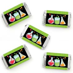 four different colored flasks on black and green candy bar wrappers