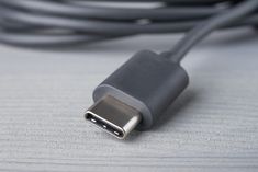 a close up of a black and silver charger cable