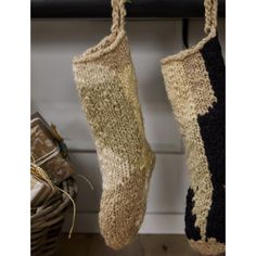 two knitted stockings hanging from a hook