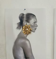 an image of a woman with large earrings on her head and hair in a bun