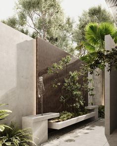 an outdoor garden with benches and trees in the back ground, surrounded by concrete walls