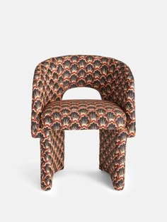 an upholstered chair with orange and black designs