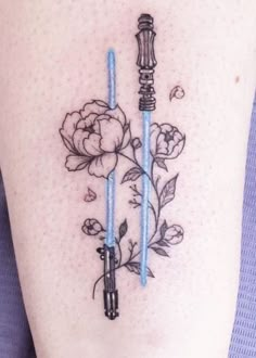 the back of a woman's stomach with two blue candles and flowers on it